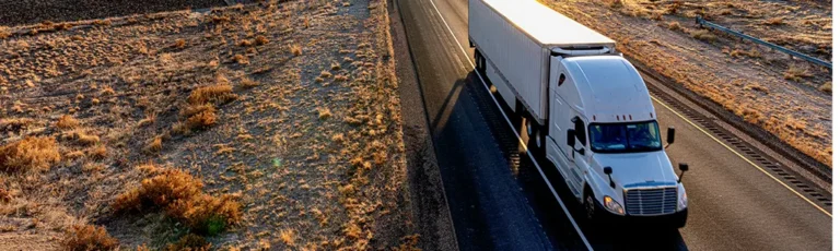 Truck Driving Down Road Using Mobil Delvac 1 ATF Transmission Fluid