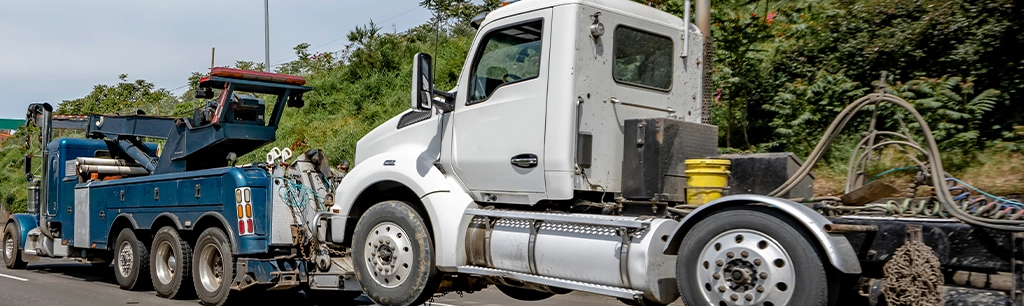 Truck Being Towed After Breakdown From Cheap Bulk Engine Oil